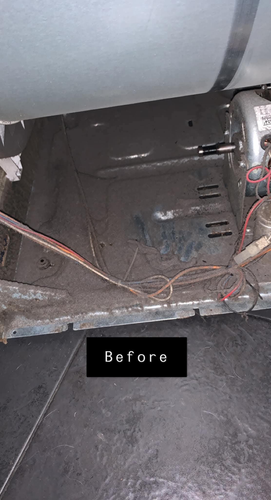Inside tumble dryer before cleaning — heavily packed with lint and fluff
