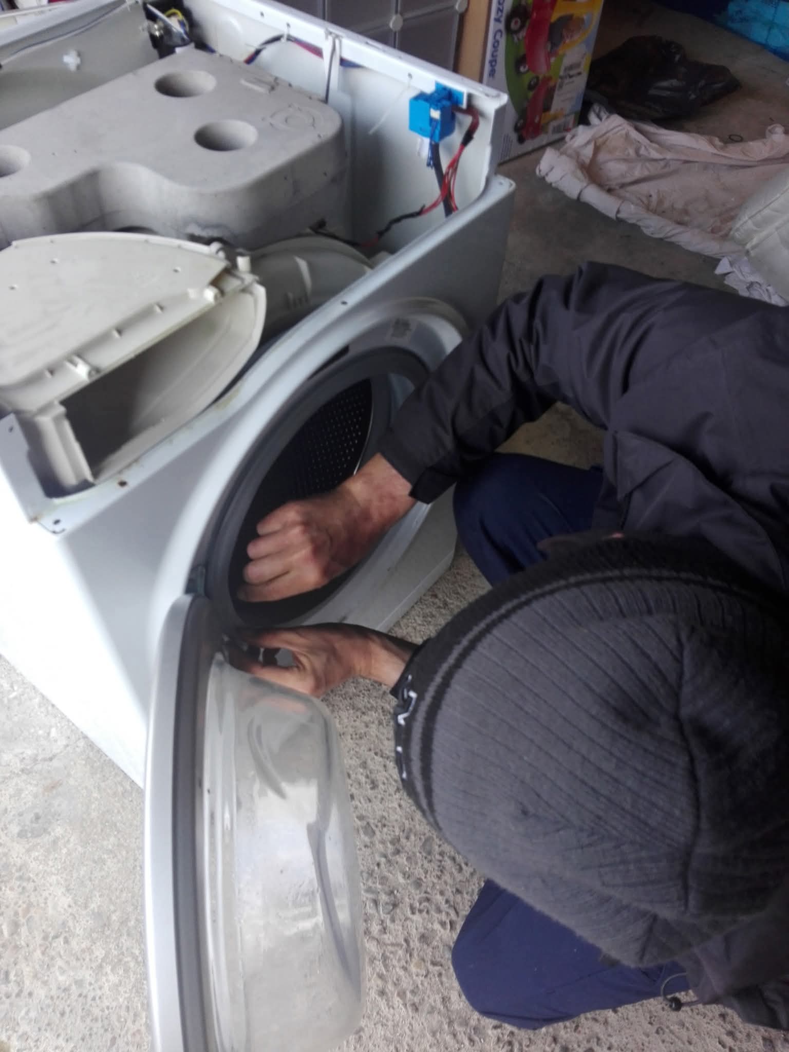 Engineer working inside washing machine